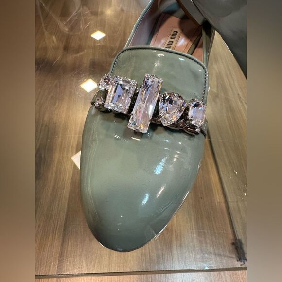 Crystal coded Miu Miu icons. Shop them on levelshoes.com Miu Miu green Patent Leather Loafers with Crystal Accents